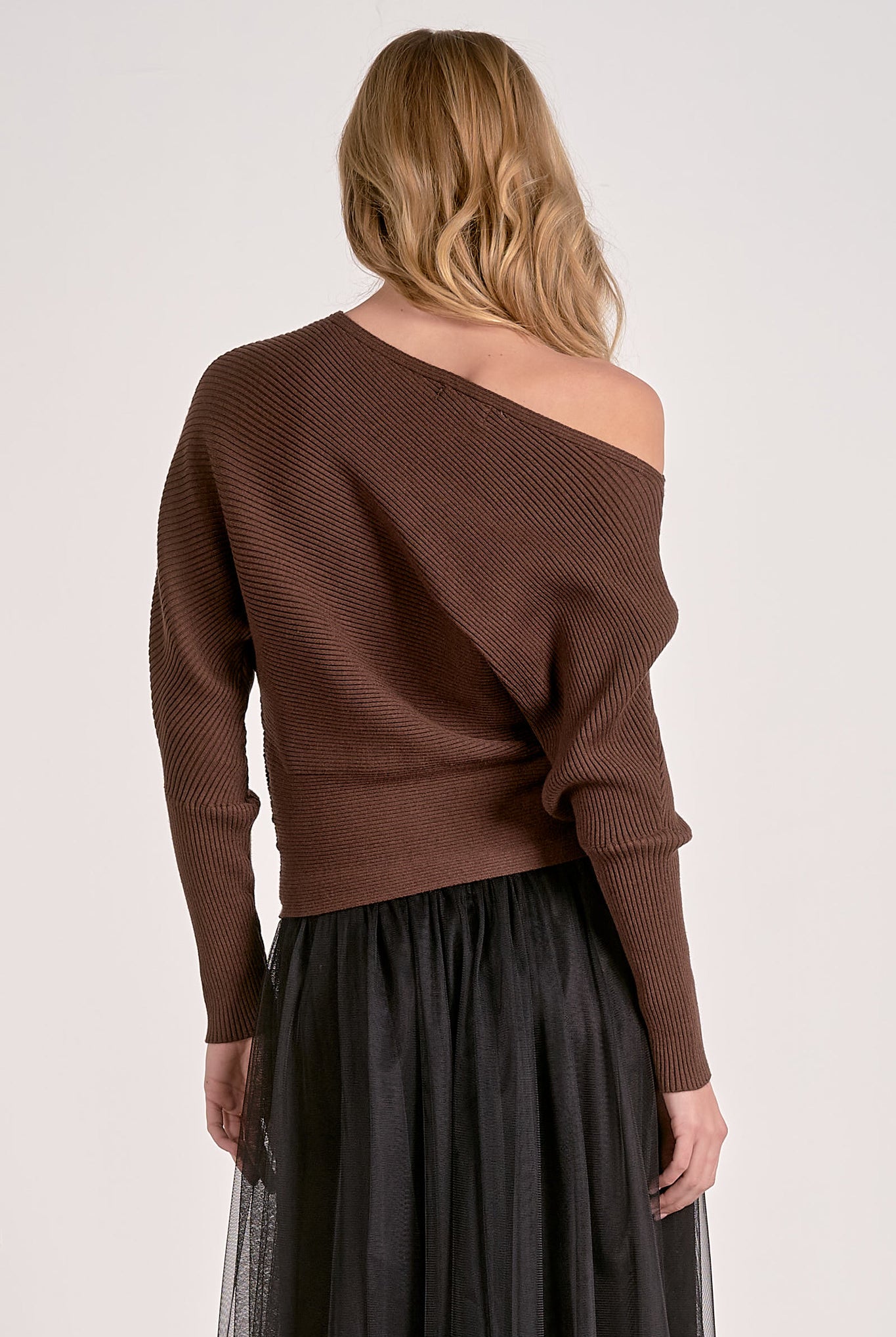 model showing back of dark chocolate off shoulder ribbed sweater with dolman sleeves