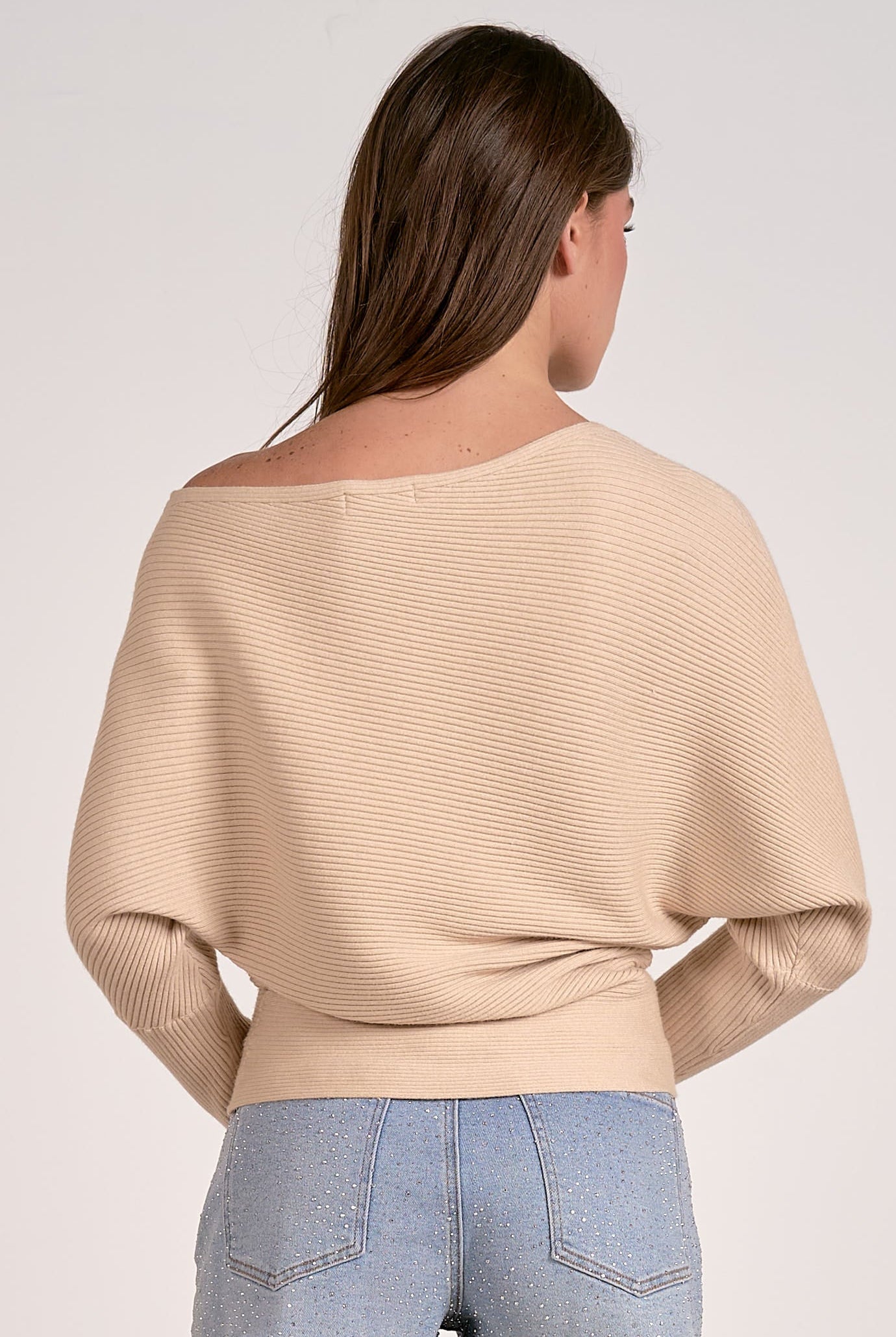 sand color off shoulder ribbed sweater styled with denim