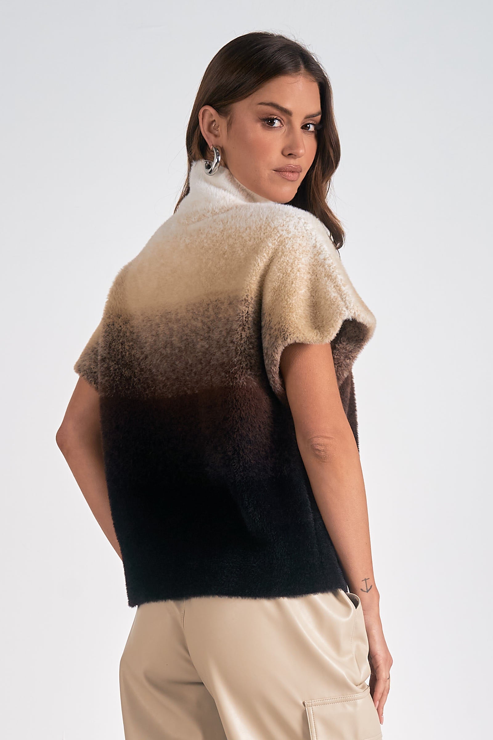 Model showing back of Horizon Ombre Dolman Sweater in cream to black gradient knit with mock neck from Mainstream Boutique Bloomington