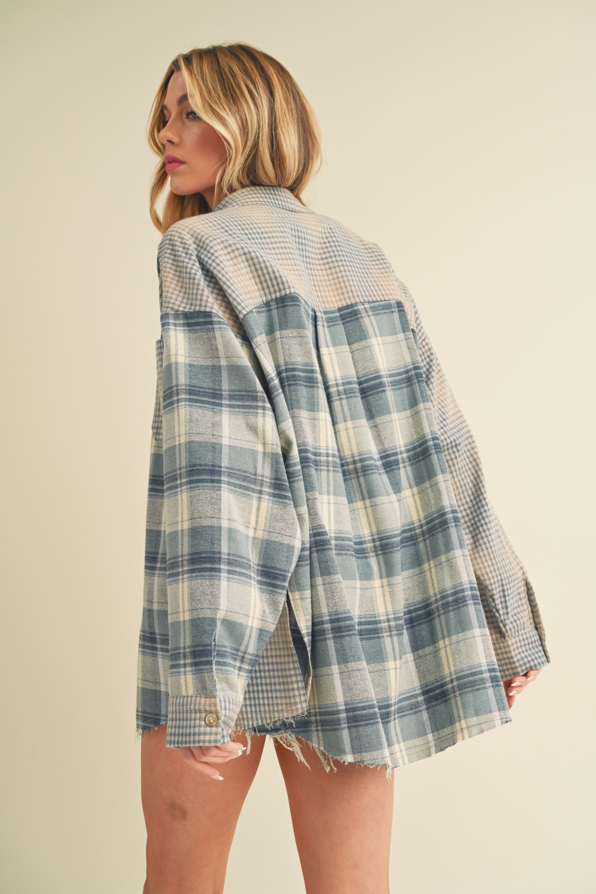 woman showing the back side of plaid flannel top