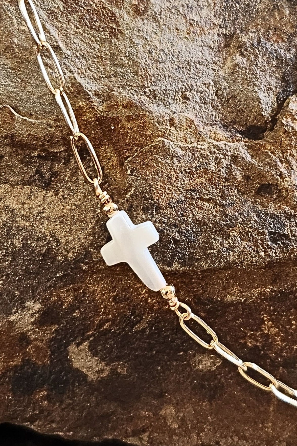 Gold chain necklace with sideways pearl cross pendant, delicate and perfect for layering