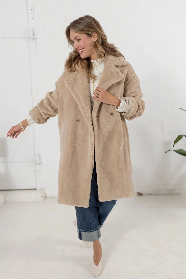 woman wearing a plush teddy coat in an oatmeal color from Mainstream Boutique Bloomington