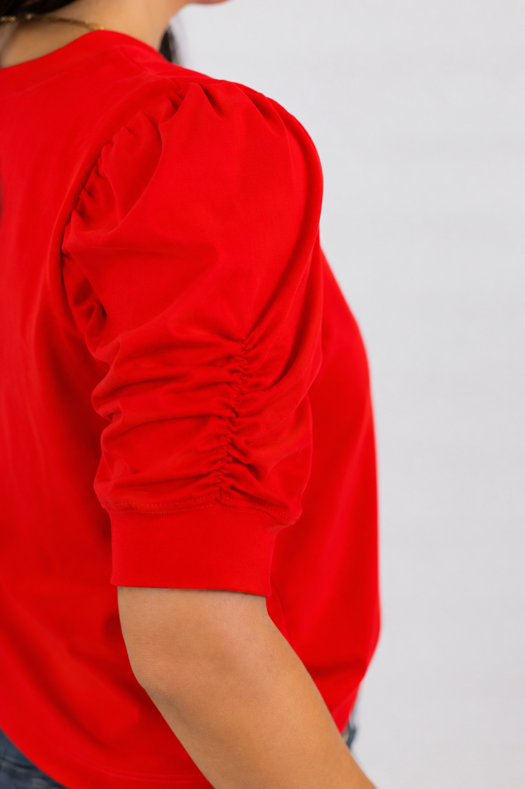 details on red elbow length ruched sleeve crew neck blouse