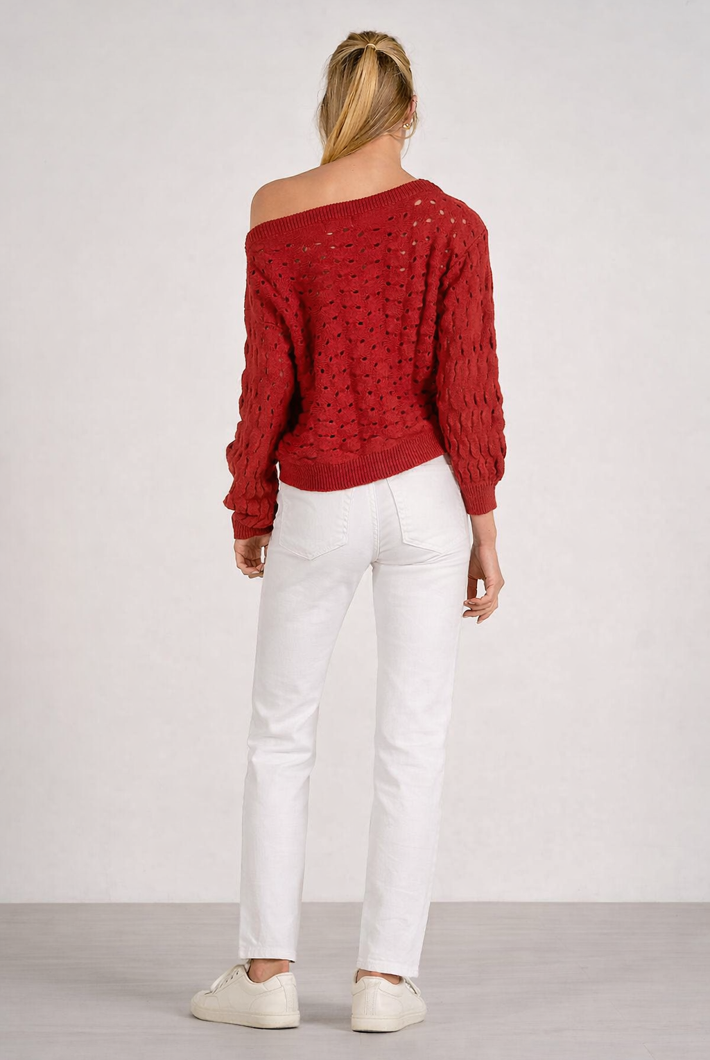 back of relaxed fit open knit sweater shown with white denim