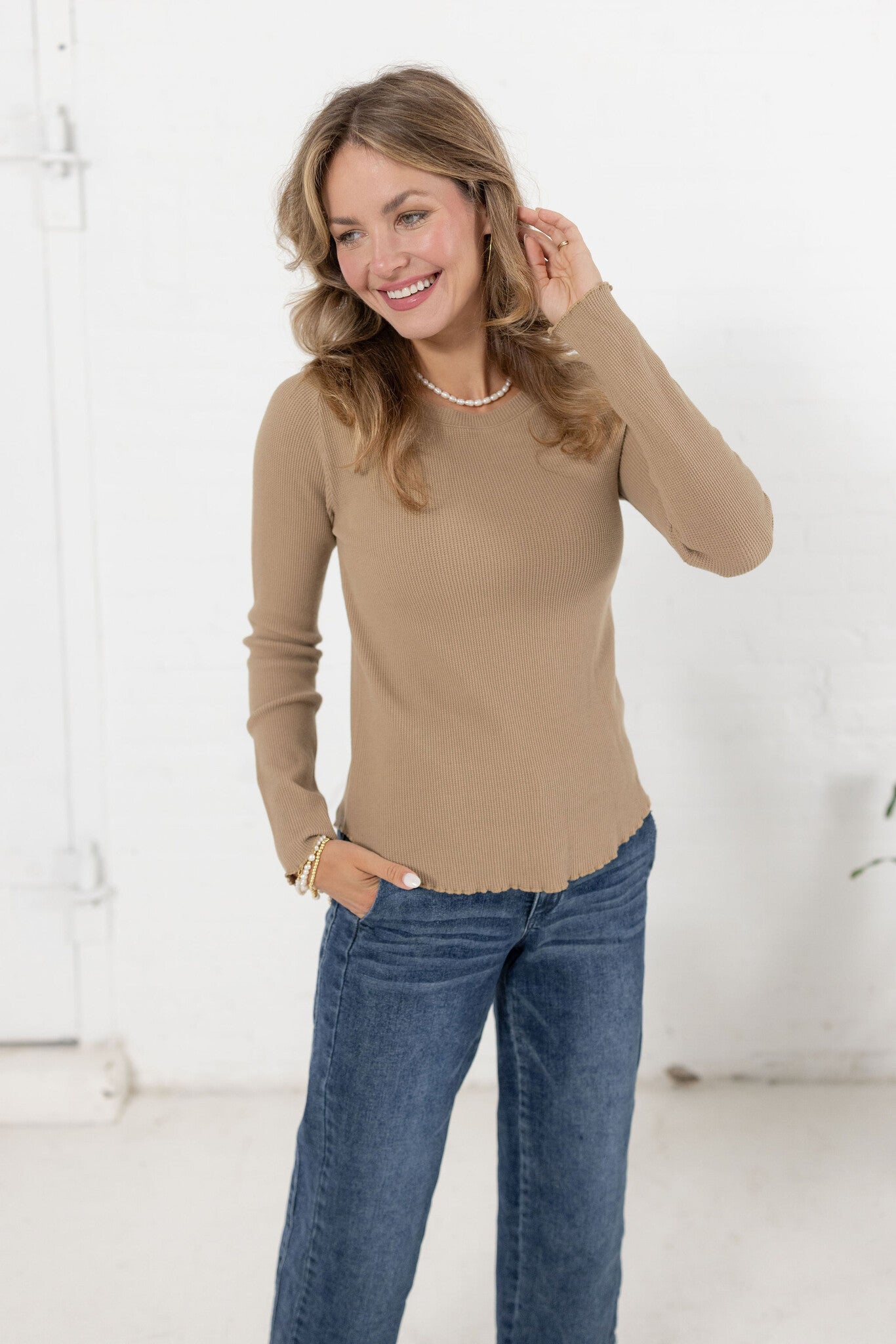 woman modeling the mac and me ribbed waffle top in tan with mac and me jeans