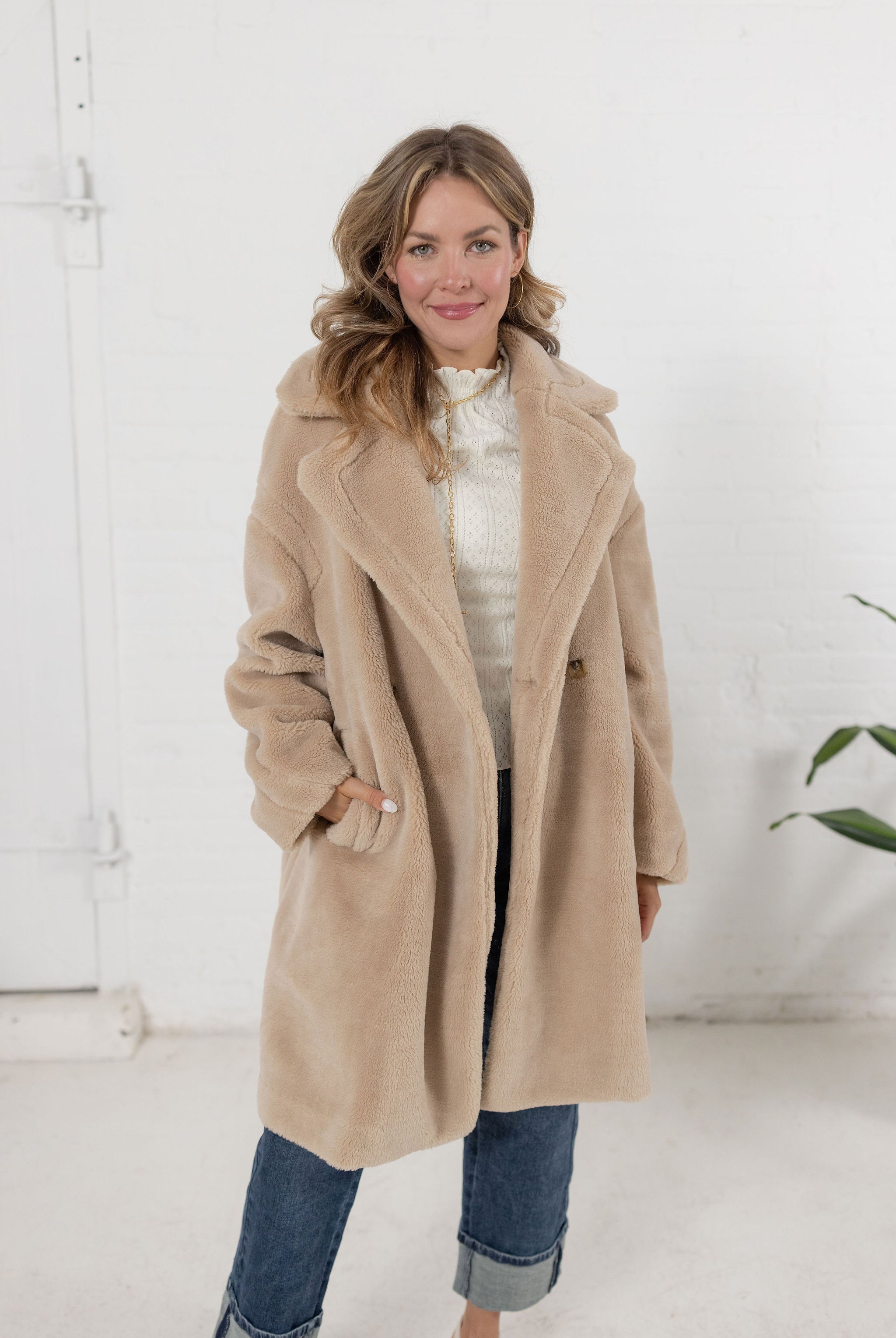 woman modeling the plush teddy coat in an oatmeal color from Mainstream Boutique Bloomington