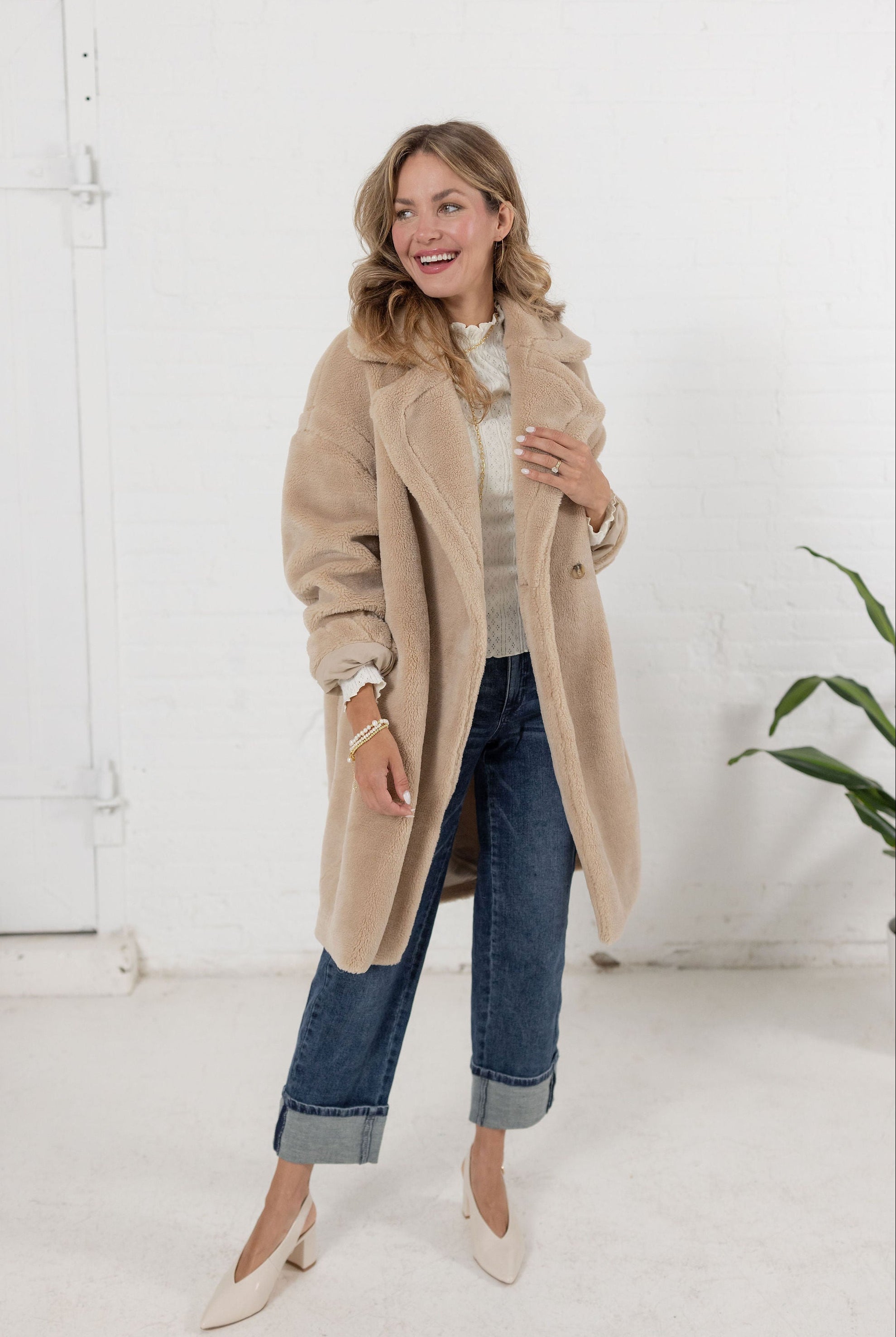 woman wearing a plush teddy coat in an oatmeal color from Mainstream Boutique Bloomington