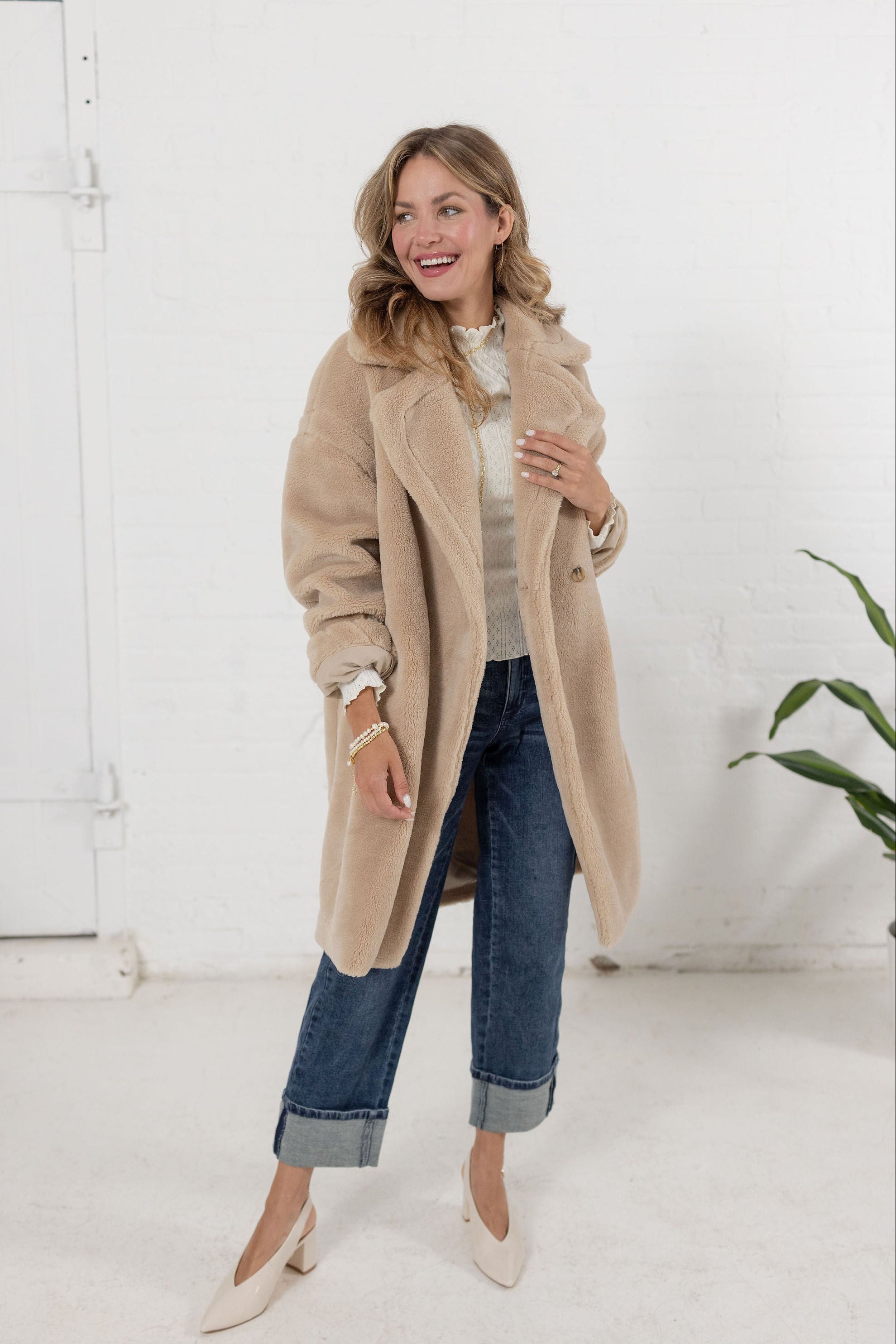 woman wearing a plush teddy coat in an oatmeal color from Mainstream Boutique Bloomington