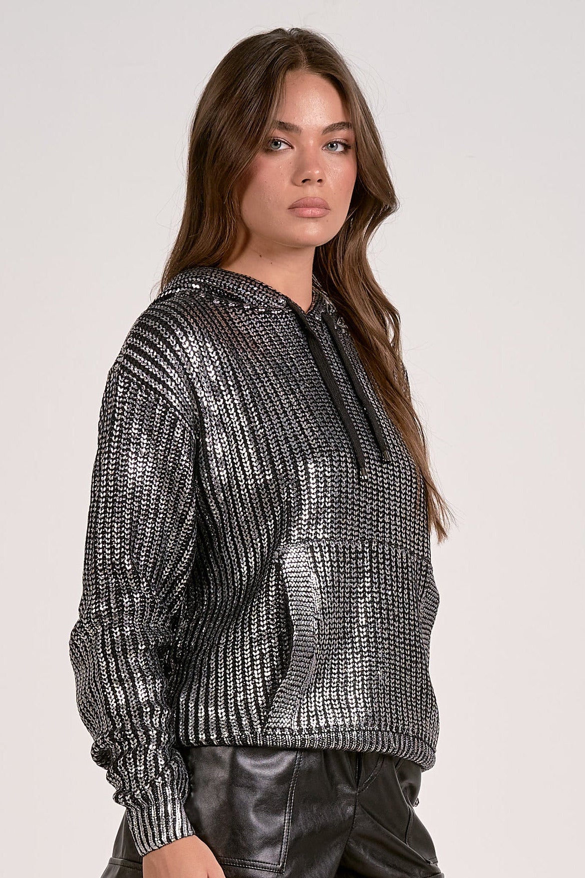 Model wearing silver Metallic Hoodie Sweater with relaxed fit and subtle shimmer from Mainstream Boutique Bloomington