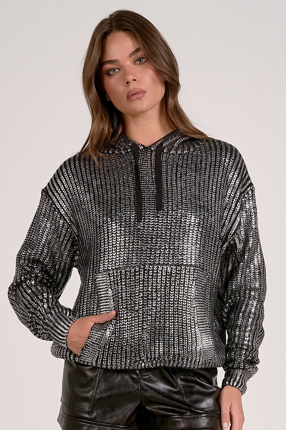 Model wearing silver Metallic Hoodie Sweater with relaxed fit and subtle shimmer from Mainstream Boutique Bloomington
