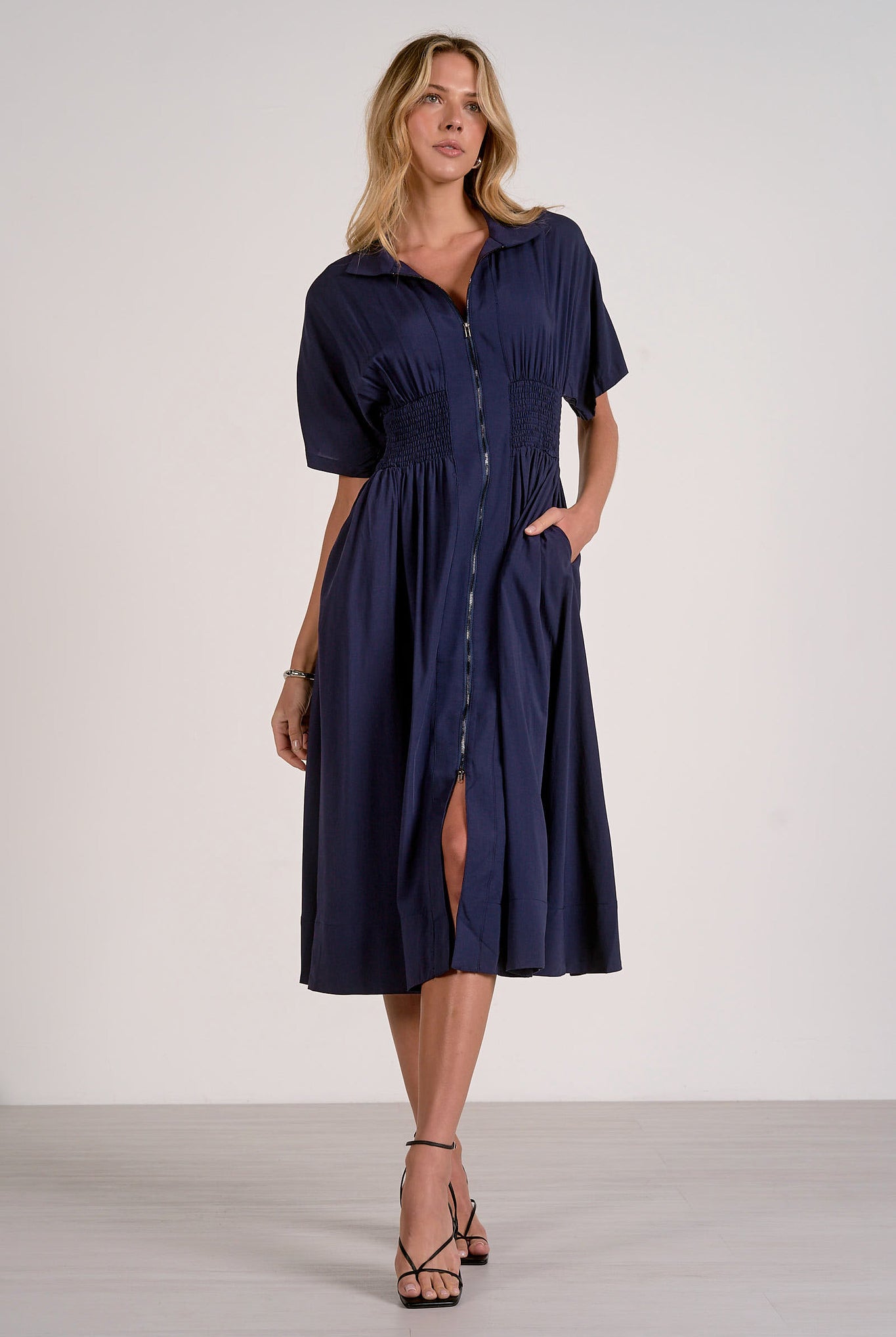 Navy smocked waist midi dress with relaxed skirt and flattering waist detail