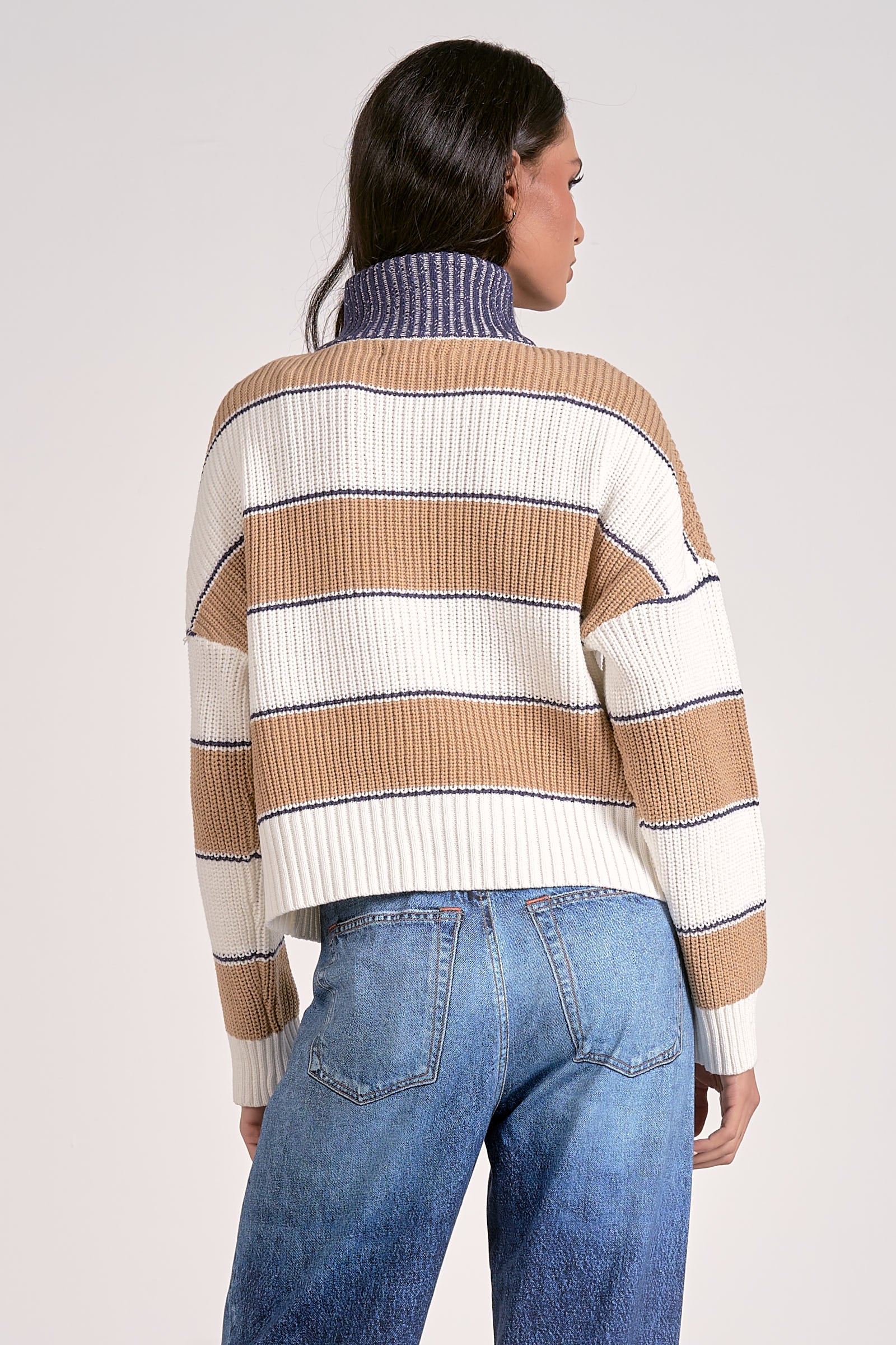 Back view of striped half zip sweater in camel white and blue waist length