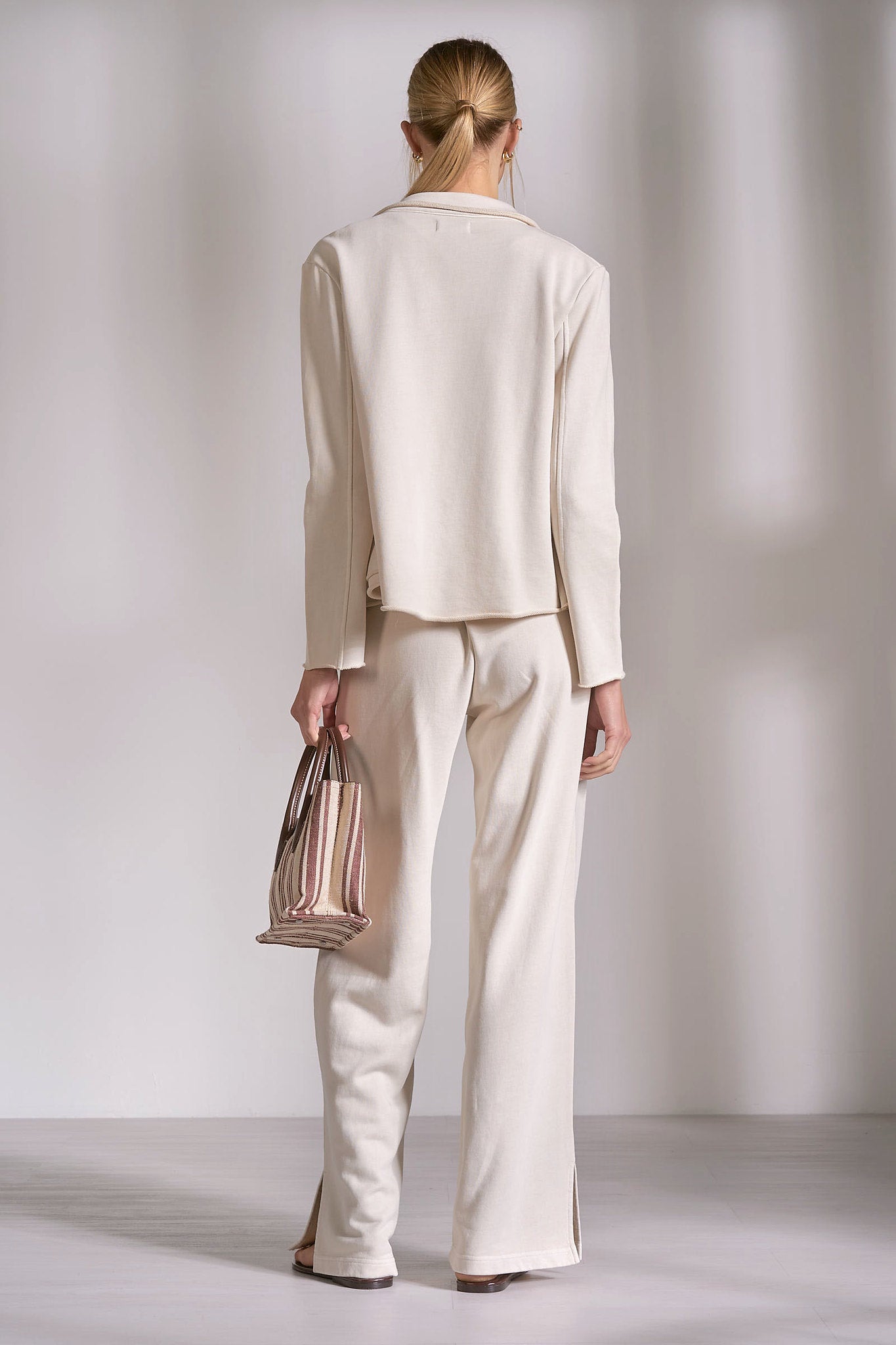 Back view of stone cotton knit blazer with relaxed structured fit