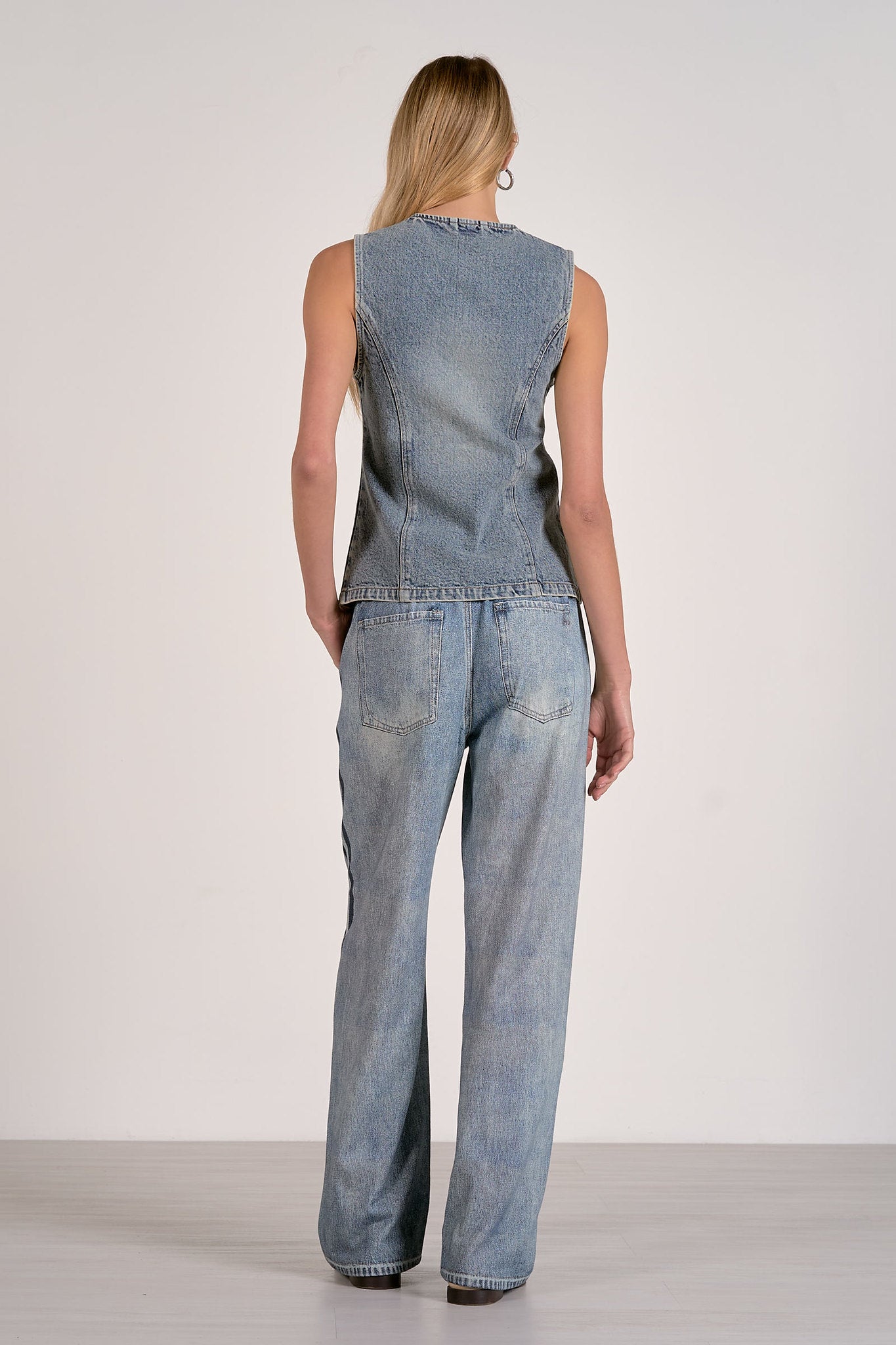 back of washed denim button front vest with tailored seam detailing