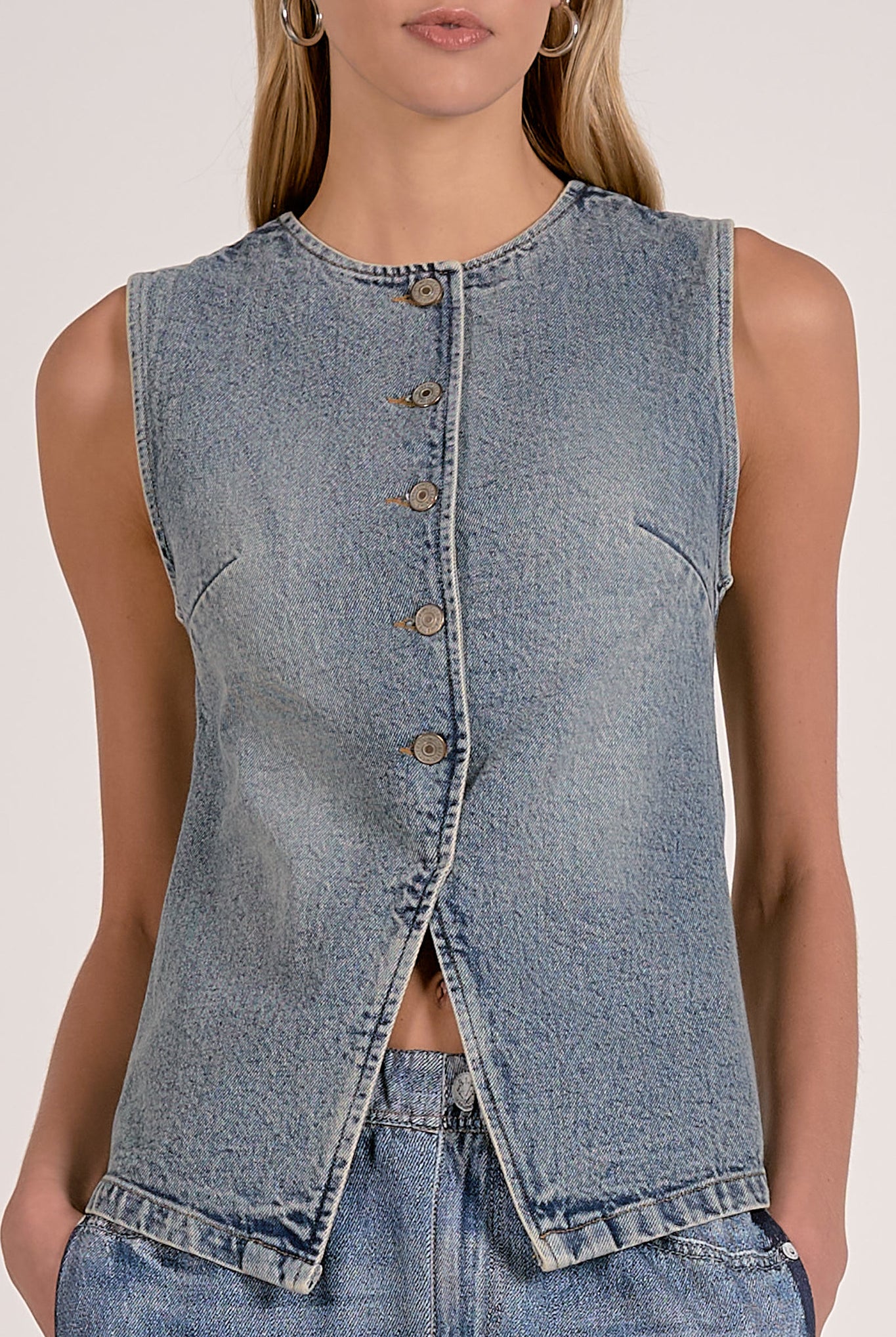 close details of the washed denim button front vest with tailored seam detailing