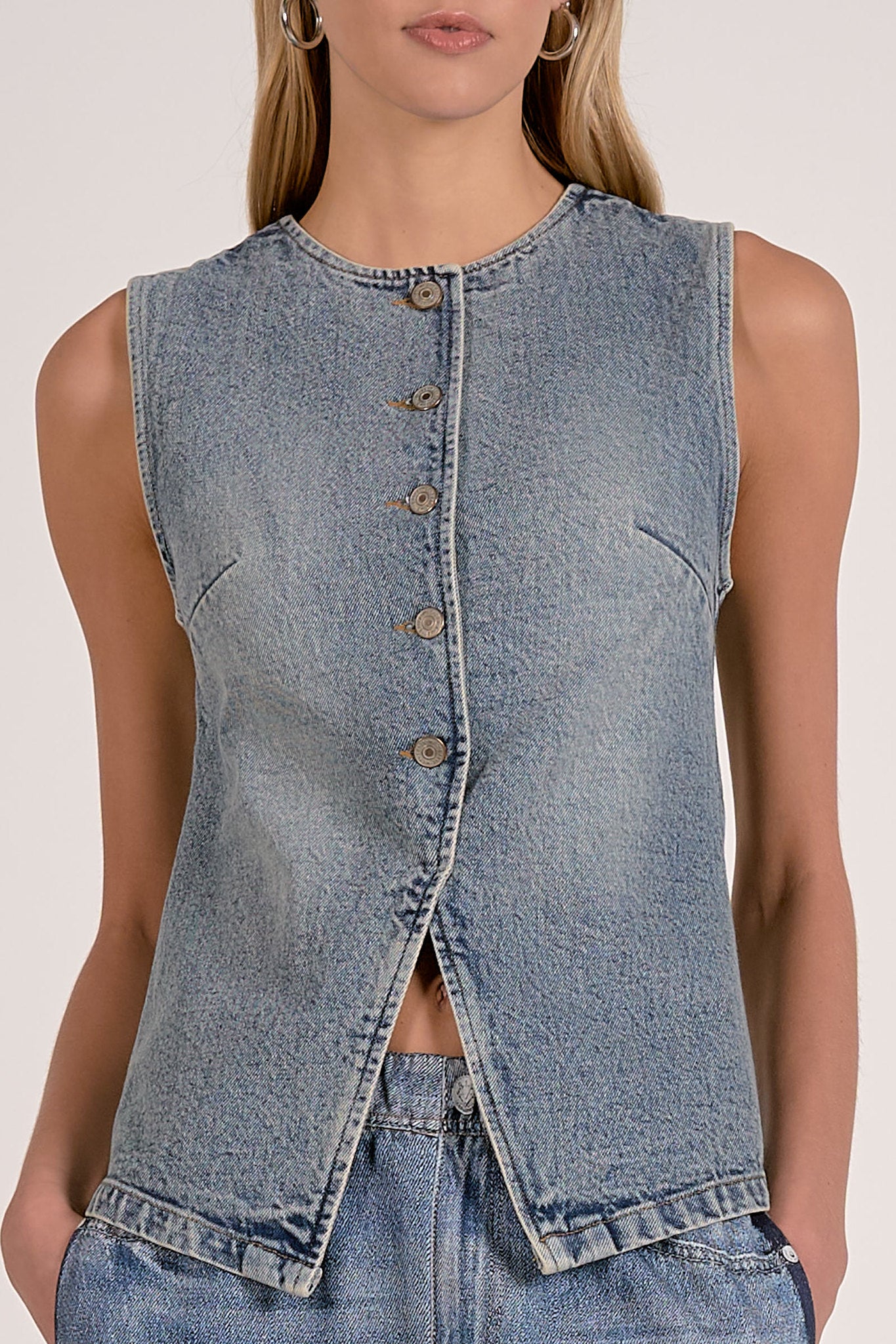 close details of the washed denim button front vest with tailored seam detailing