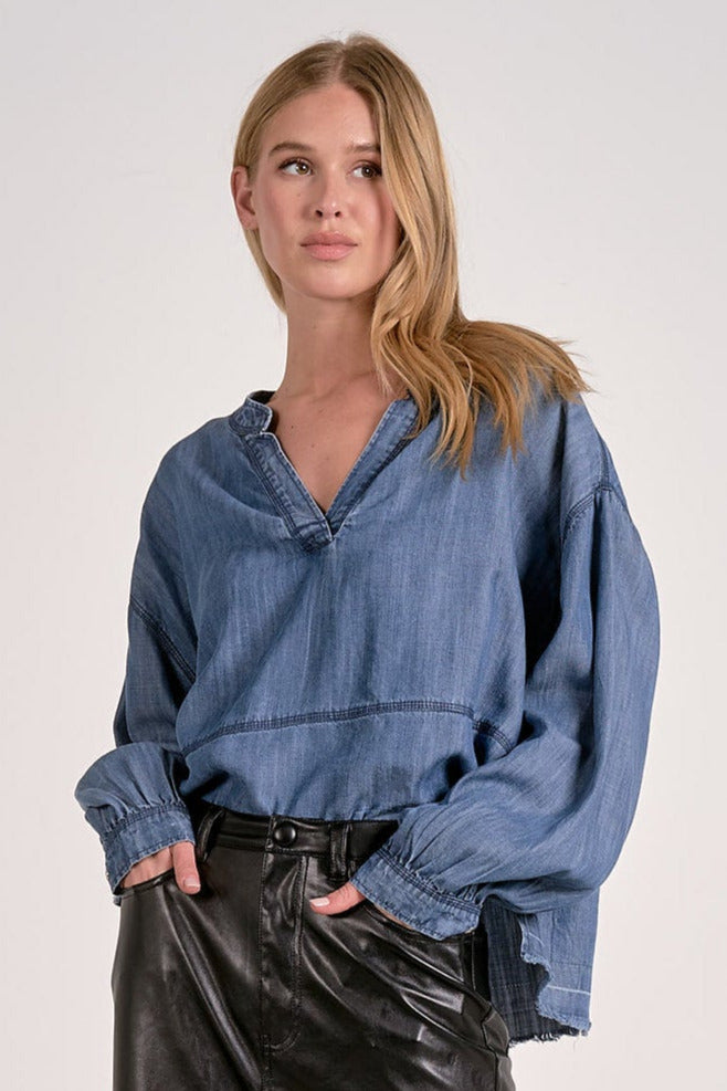 woman wearing the v-neck pullover top, tucked in front