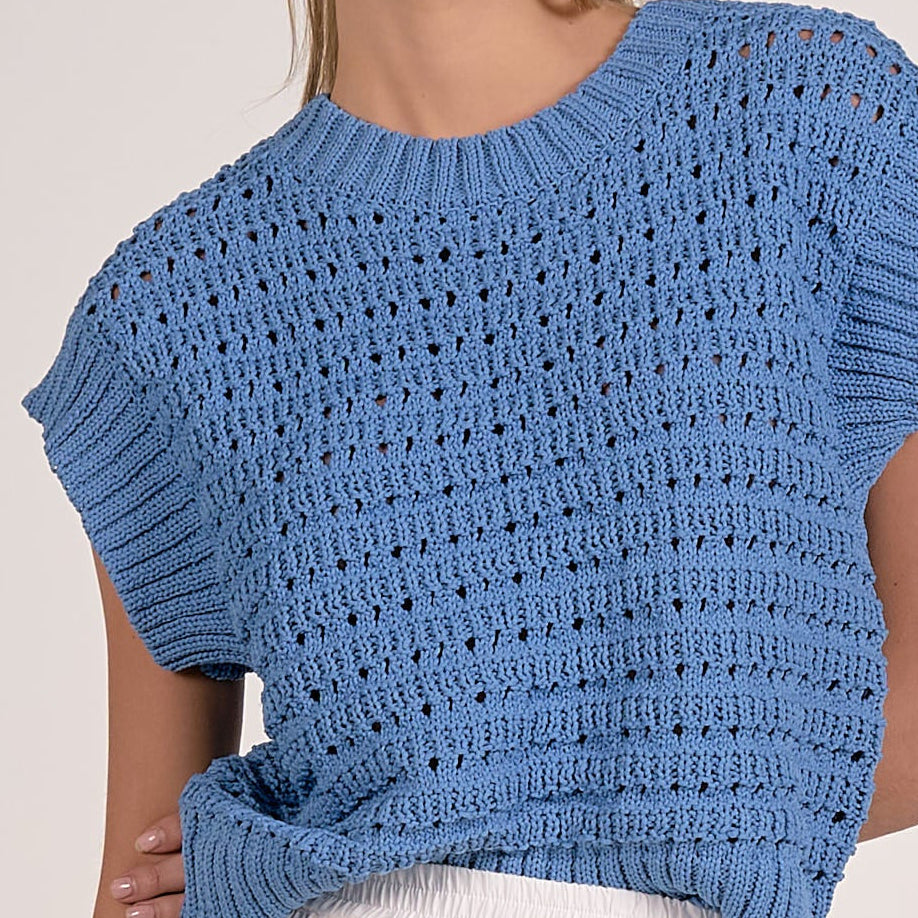 close up details on vibrant blue textured open knit cap sleeve sweater with ribbed trim