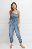 Woman wearing soft Tencel denim jumpsuit with relaxed fit and sustainable fabric from Mainstream Boutique Bloomington