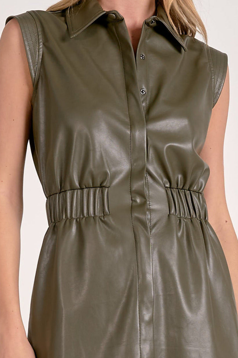 Woman showing the details on the elastic faux leather dress.