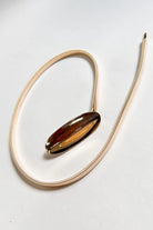 Polished gold elastic belt featuring sleek oval buckle