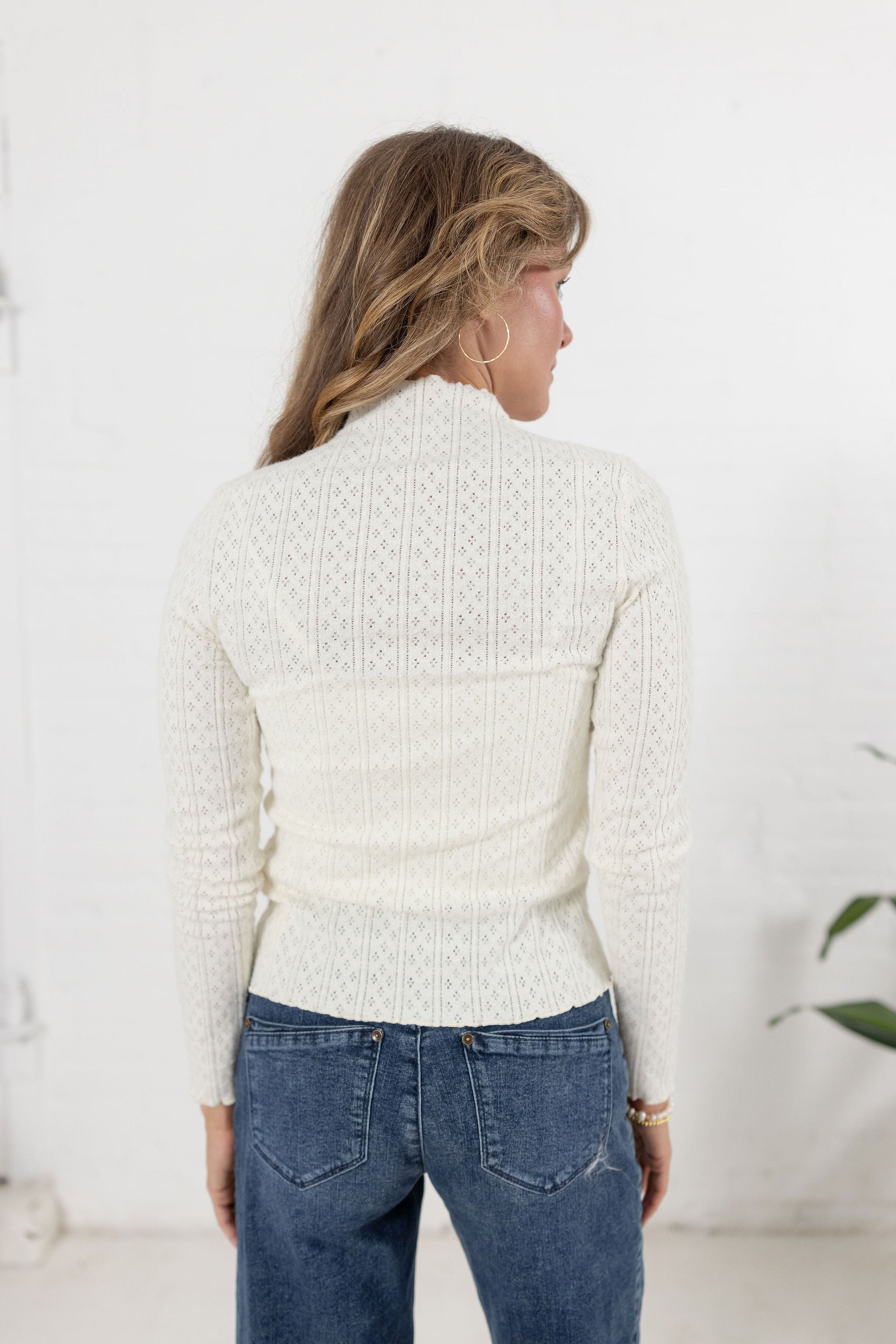 woman showing the back of the lettuce edge top in ivory