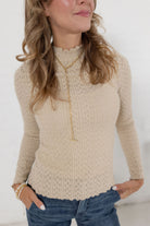 close up of the lettuce edge detail fitted mock neck top in almond