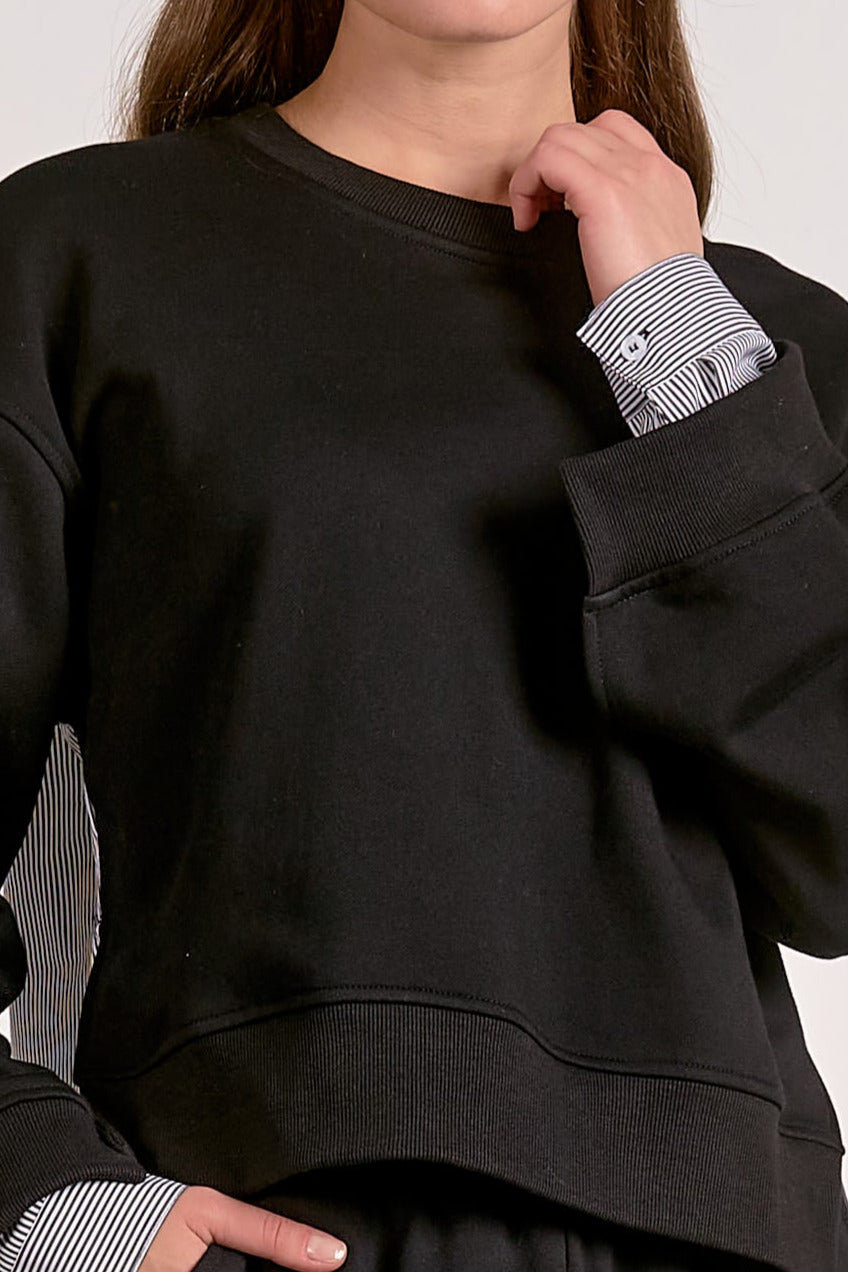 showing the closer details of the black mixed media crewneck sweatshirt with striped woven back