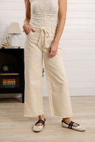 front view of Mac and Me skyrise wide leg drawstring jeans frayed hem