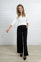 Woman walking in the black Mac and Me trouser.