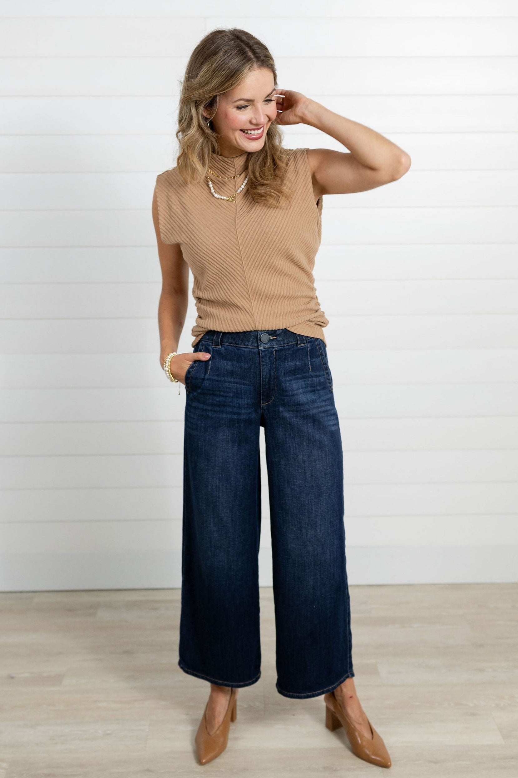 Model showing the front of the Mac and Me Wide Leg Trouser Jean.  She is also wearing a Mac and Me Funnel Neck top in the color carmel, as well as carmel colored pumps.
