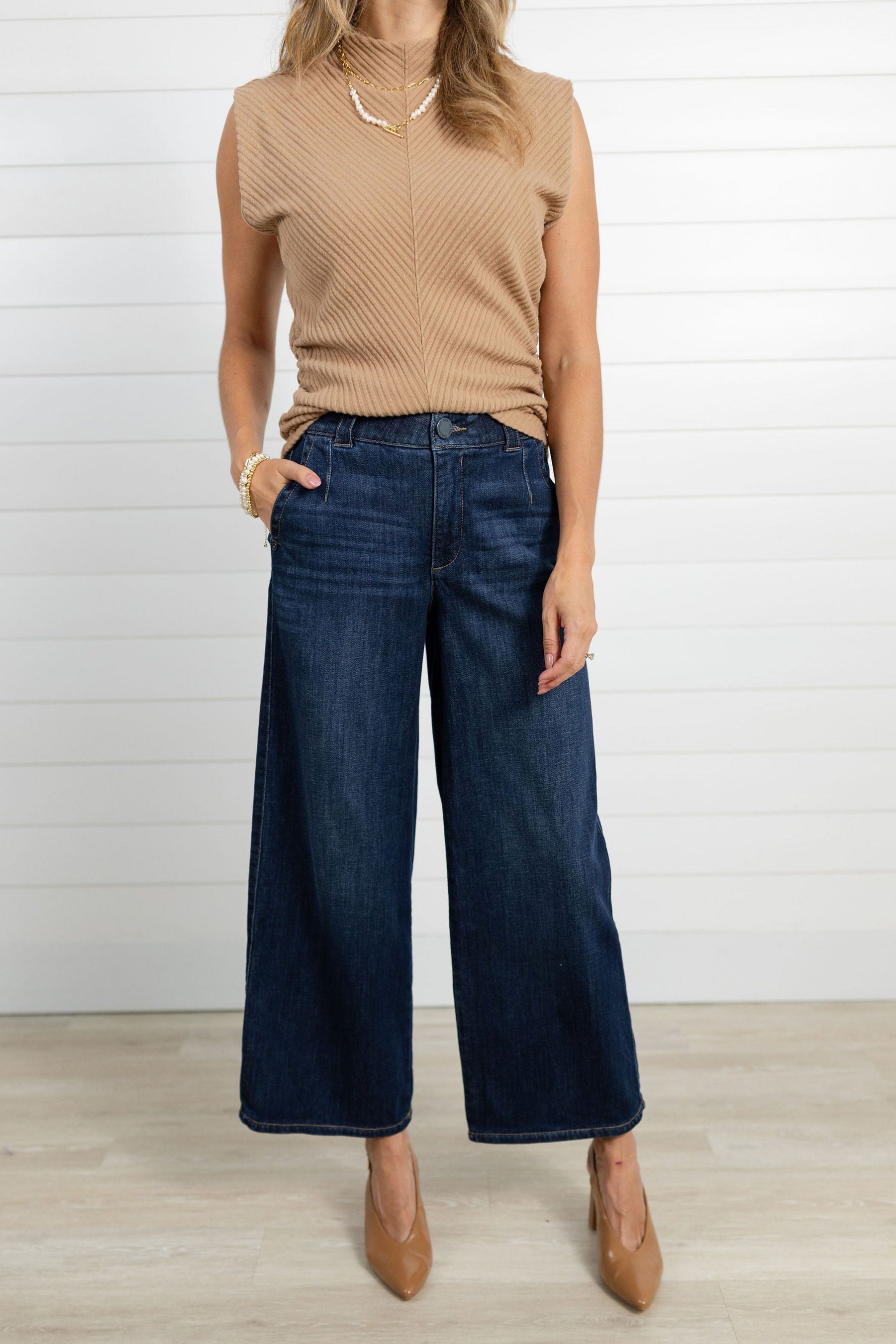 Model wearing the Mac and Me Trouser Jeans and a carmel funnel neck top by Mac and Me.  She is also wearing carmel-colored pumps.