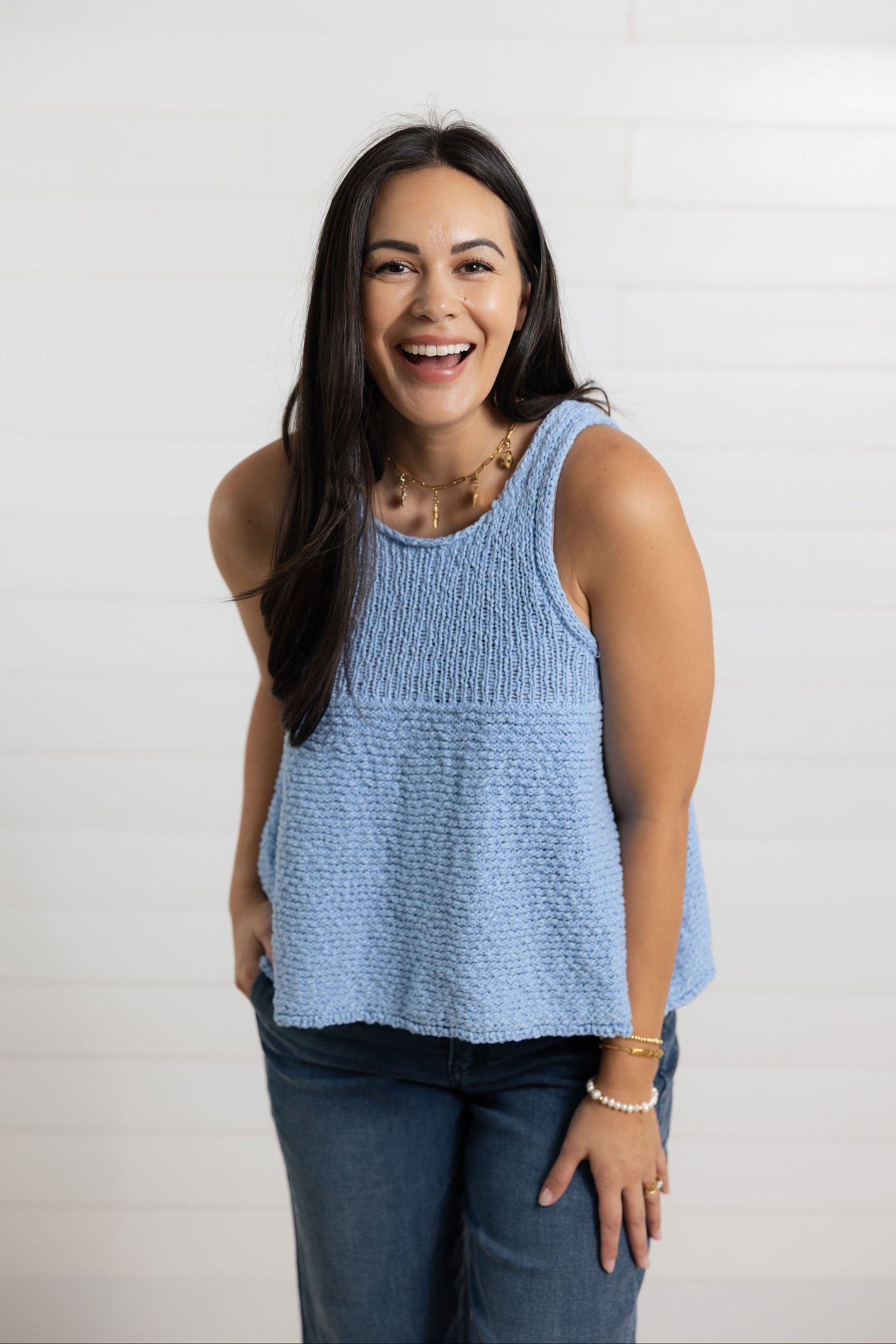 woman showing the front of mac and me swing sweater top in light blue