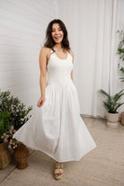 model turning in white mixed media eyelet dress