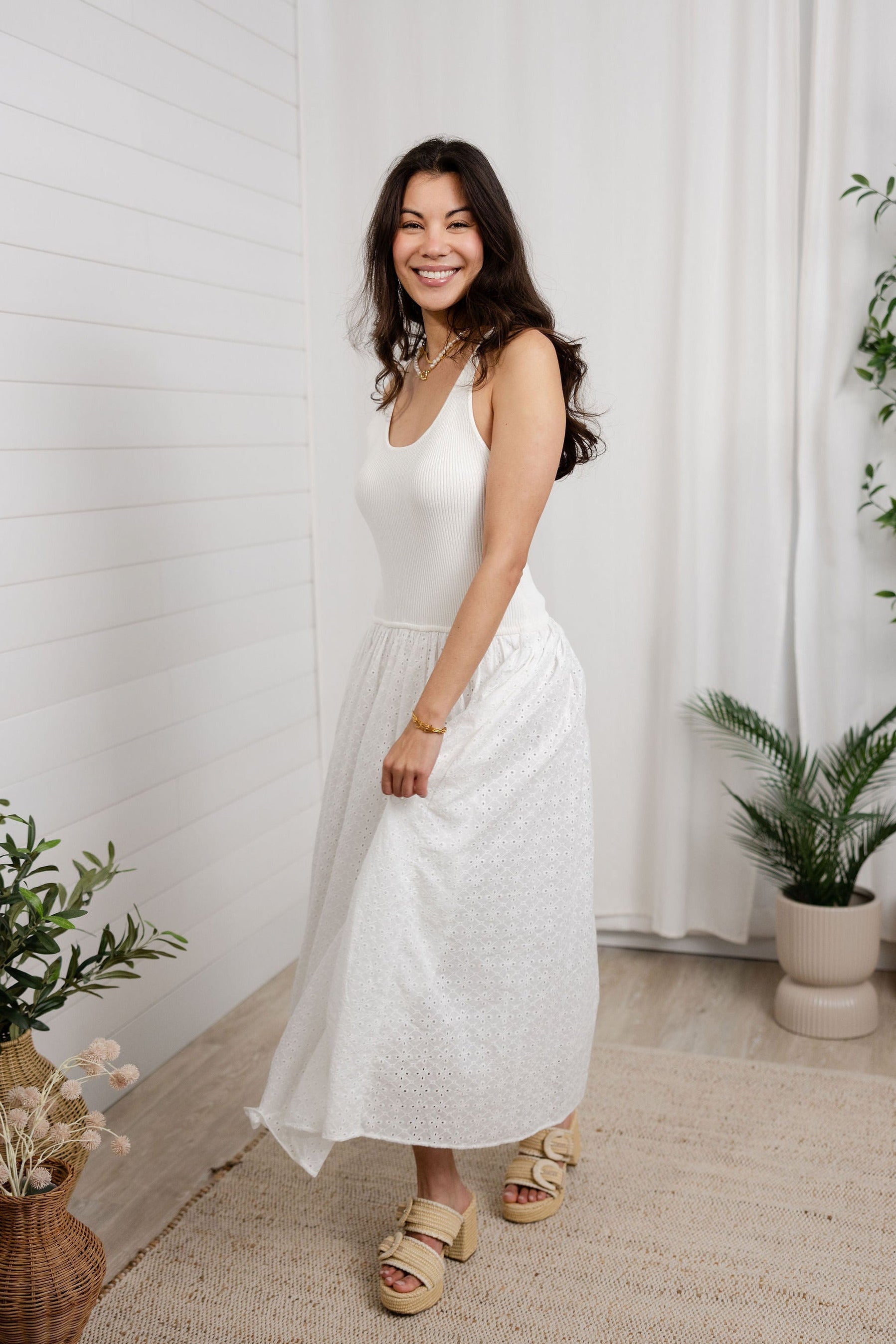 model moving in white mixed media eyelet dress