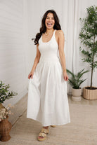 model showing front of white mixed media eyelet dress