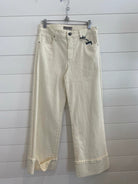 High rise wide leg denim with a bottom cuff in the color candle (ecru)