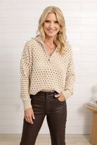 Woman wearing the open knit quarter zip sweater in oatmeal color.
