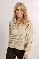 Woman modeling the open knit quarter zip sweater in oatmeal color