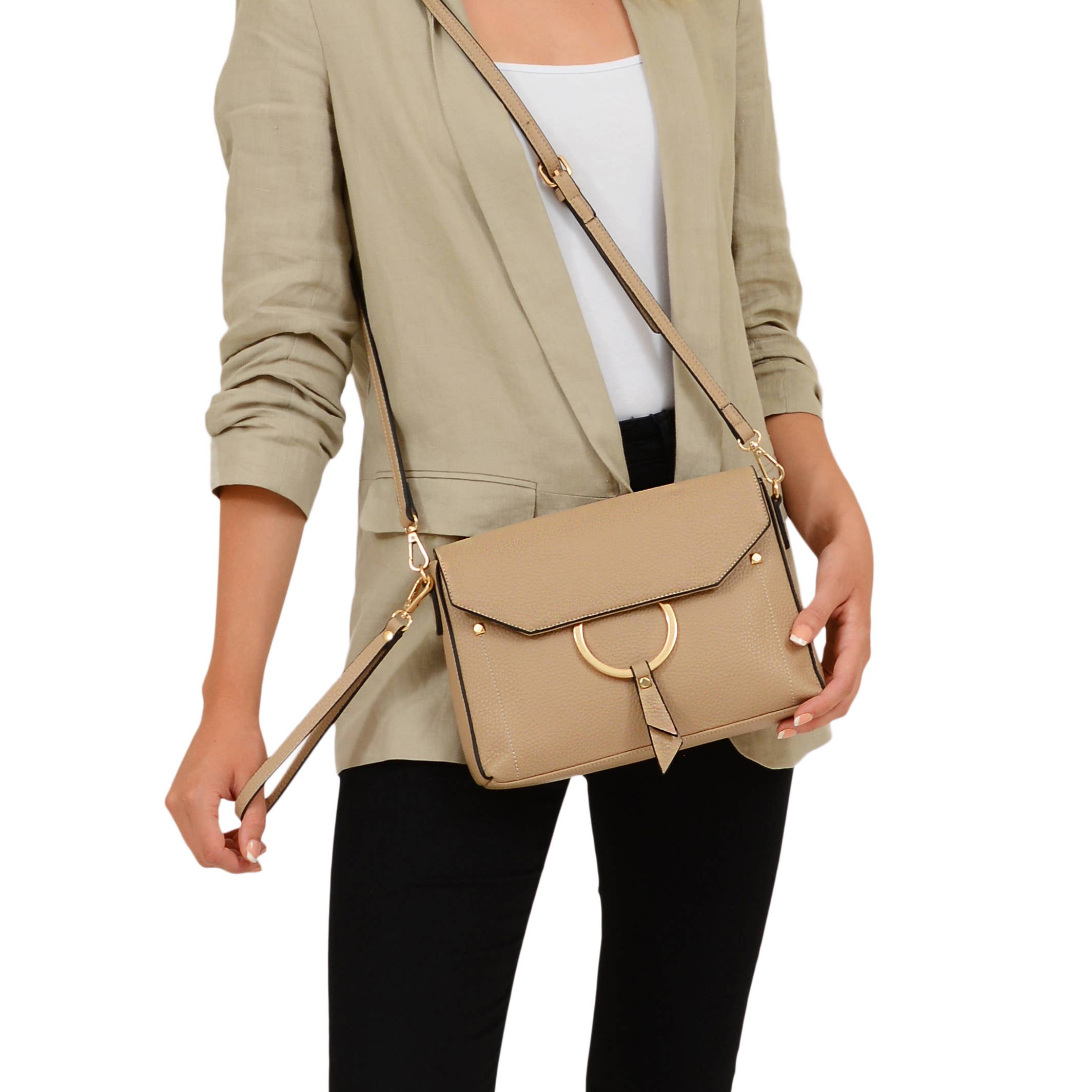 A woman holding the wristlet of the Portia Crossbody as well as the adjustable shoulder strap on the purse