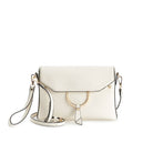 Portia Crossbody in white vegan leather with champagne gold hardware — photo shows the wristlet strap included at Mainstream Boutique Bloomington