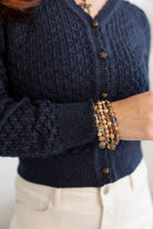 Details of a pointelle Cardigan with Rose Button in Indigo.