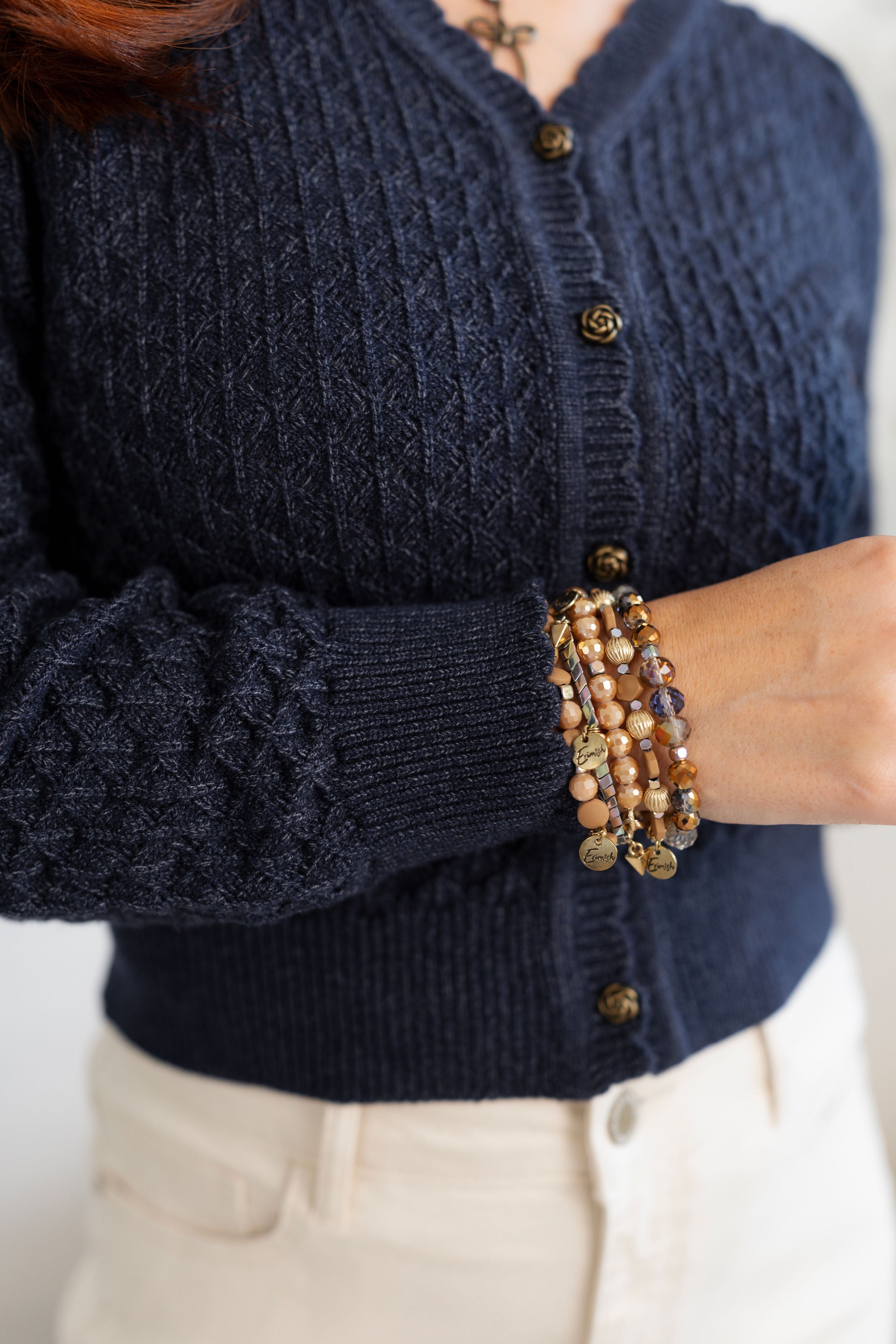 Details of a pointelle Cardigan with Rose Button in Indigo.