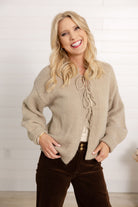 woman showing the front of the tie front sweater in macchiato