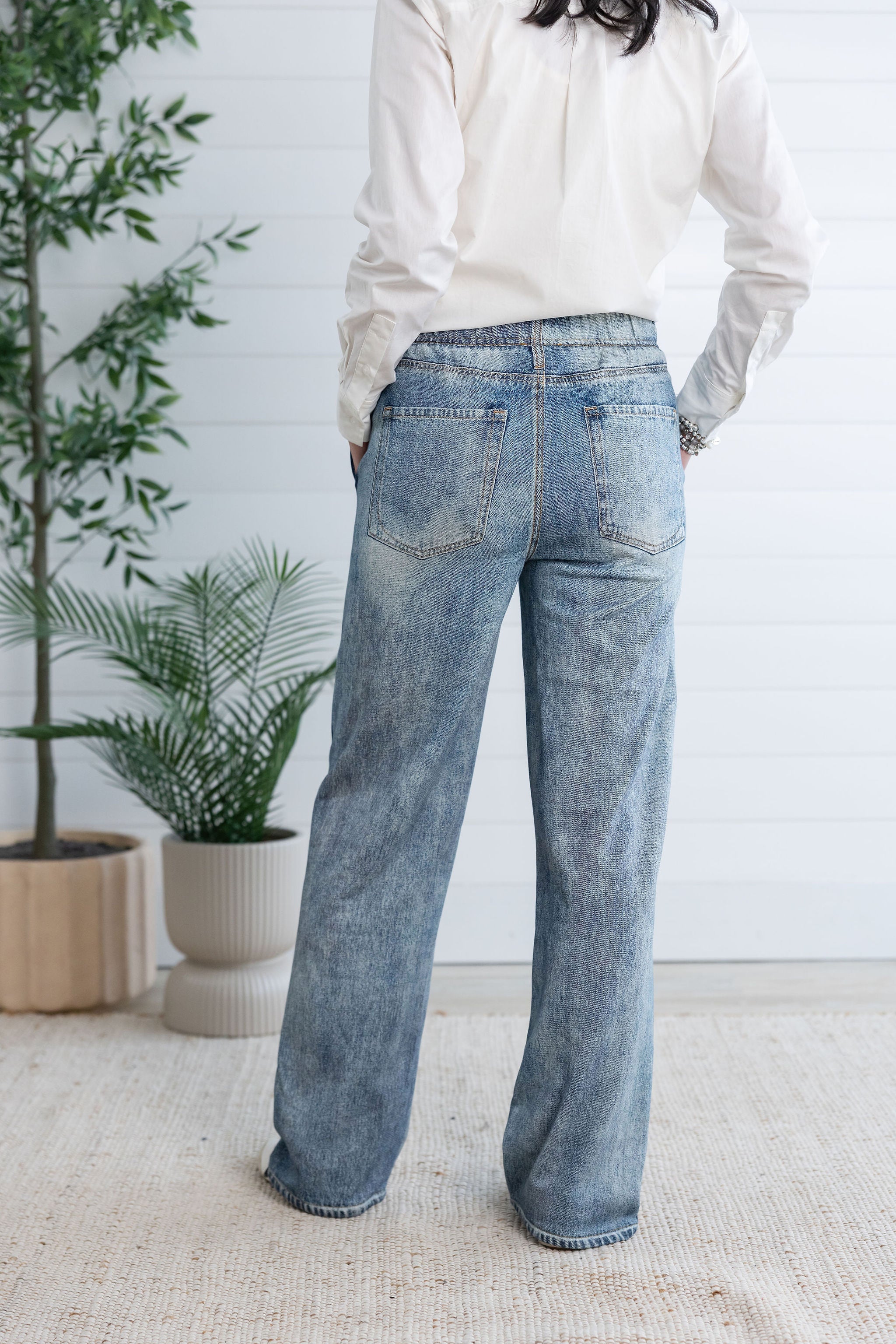 woman modeling back of lounge pant, the light blue Side Stripe Relaxed Denim Pant