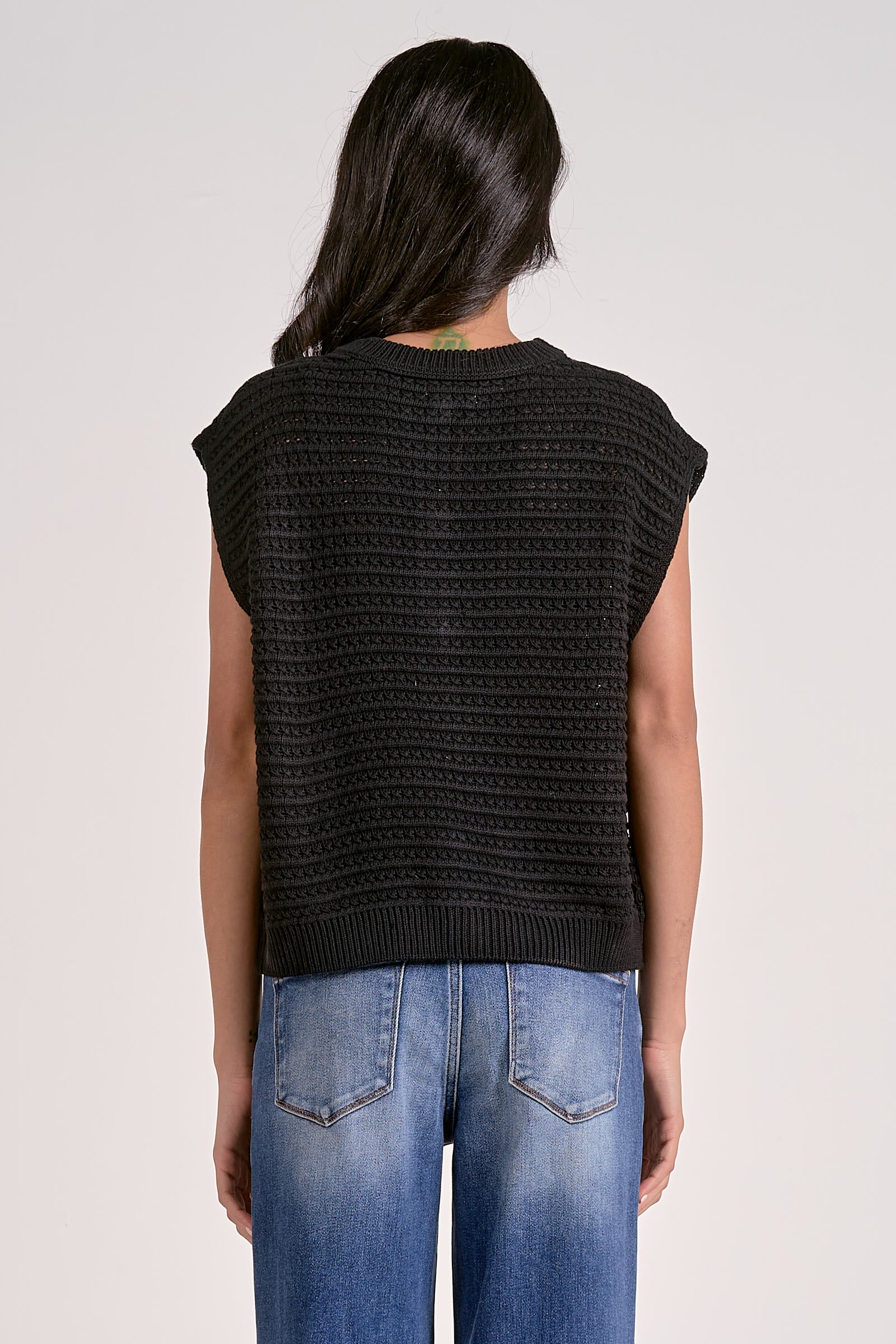 Woman showing the back of the cap sleeve sleeveless cardigan
