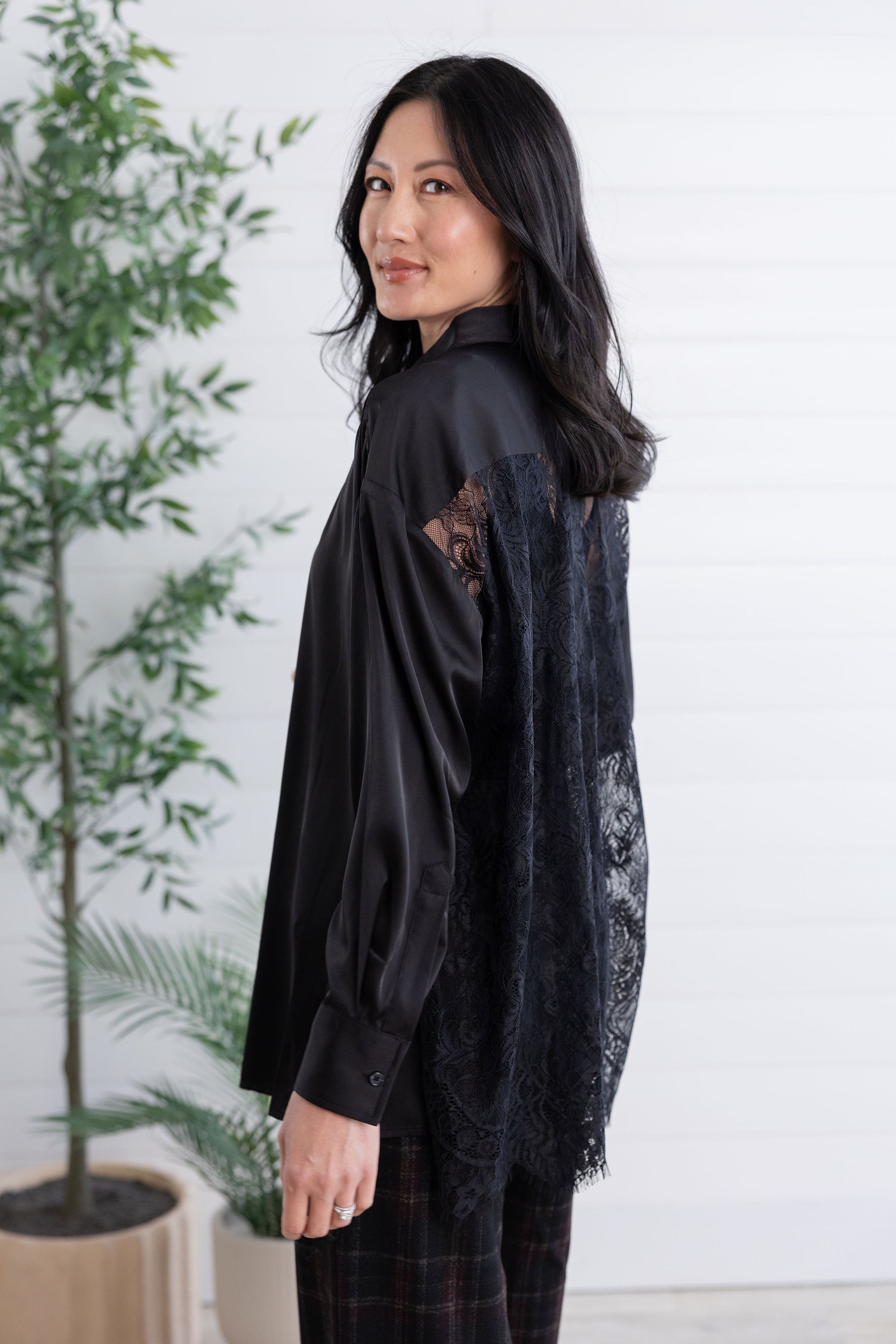 side view of black lace-back button down