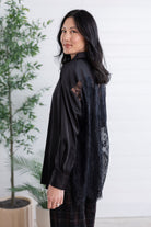 side view of black lace-back button down