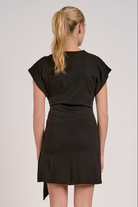 back of simple black dress with flattering waist tie and relaxed fit