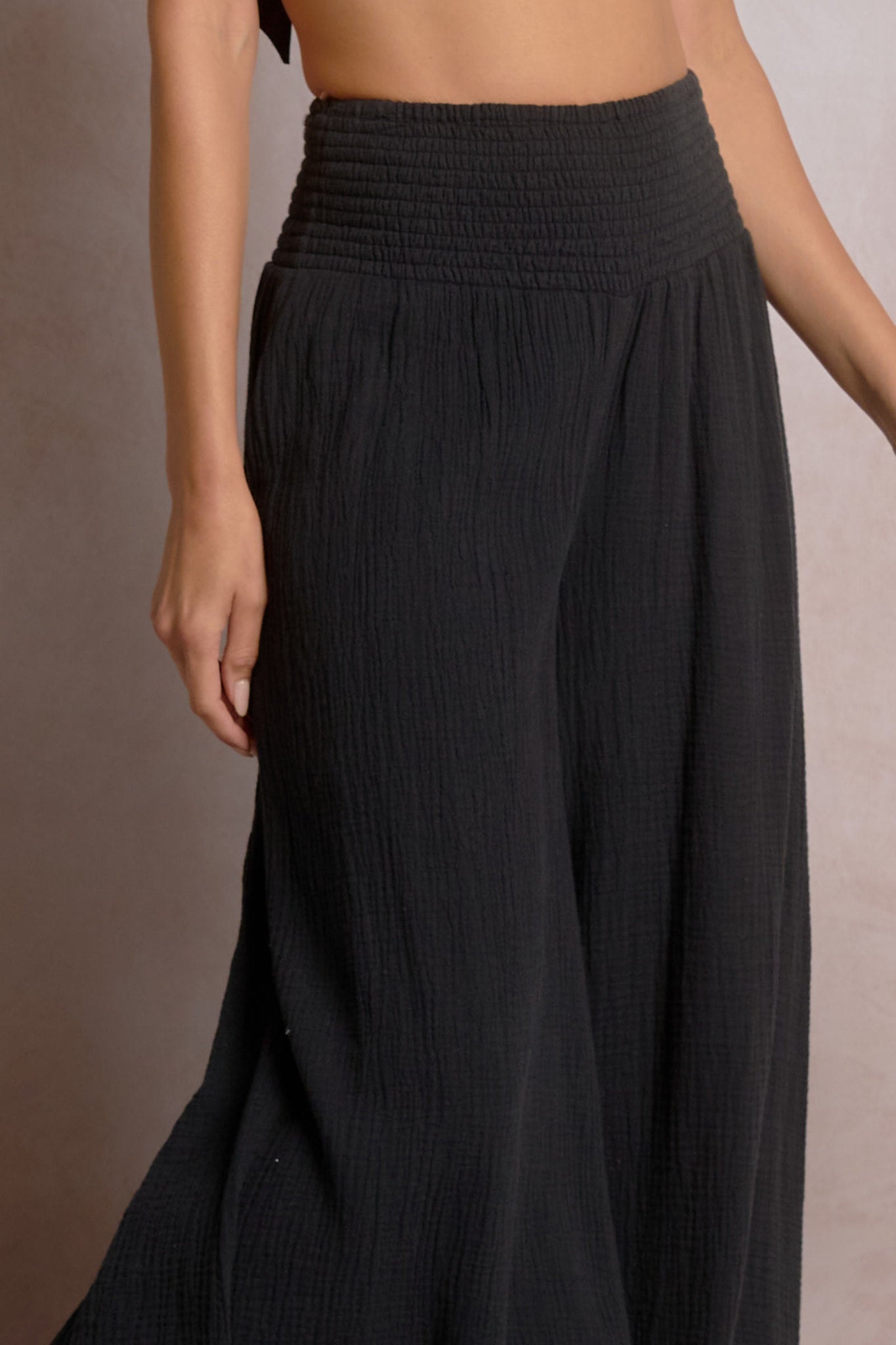 detailed view of black smock waist wide leg pants